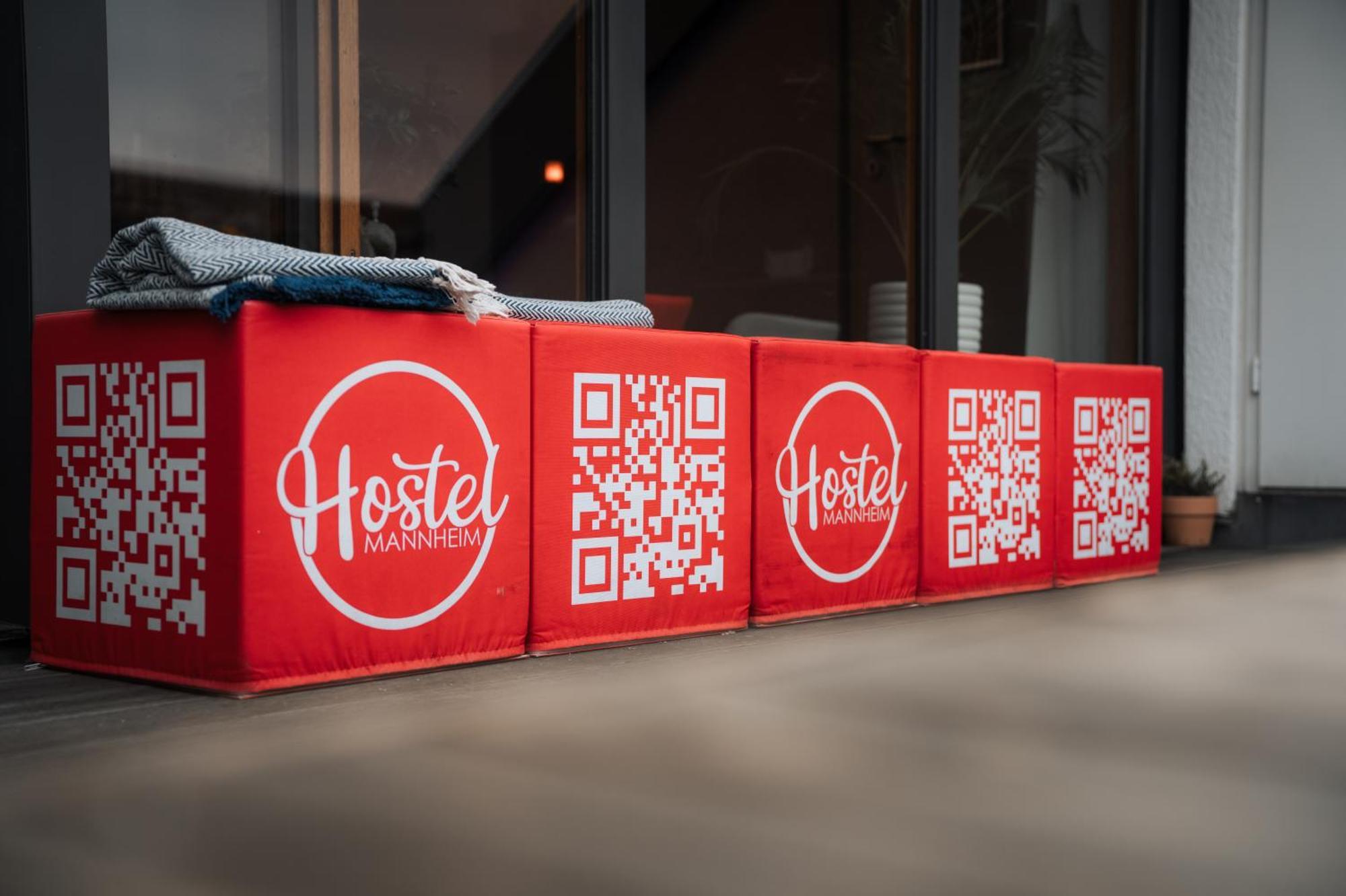 Hostel MHG Exterior foto QR codes on a bench
